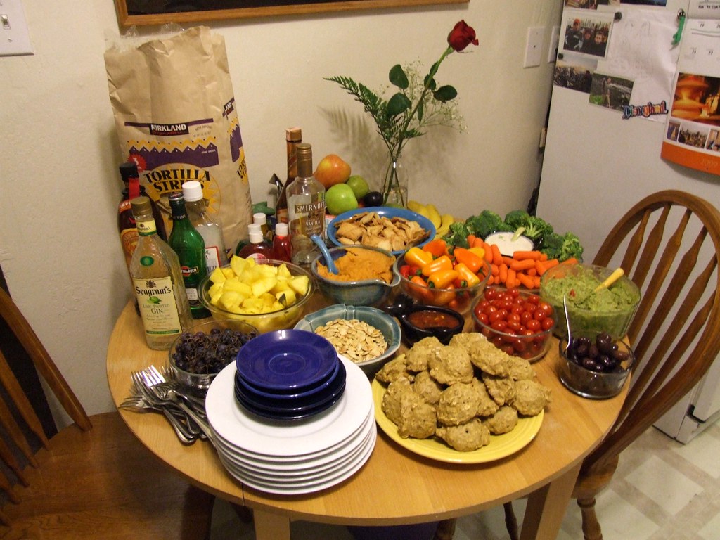A dining table with a feast spread out on it
