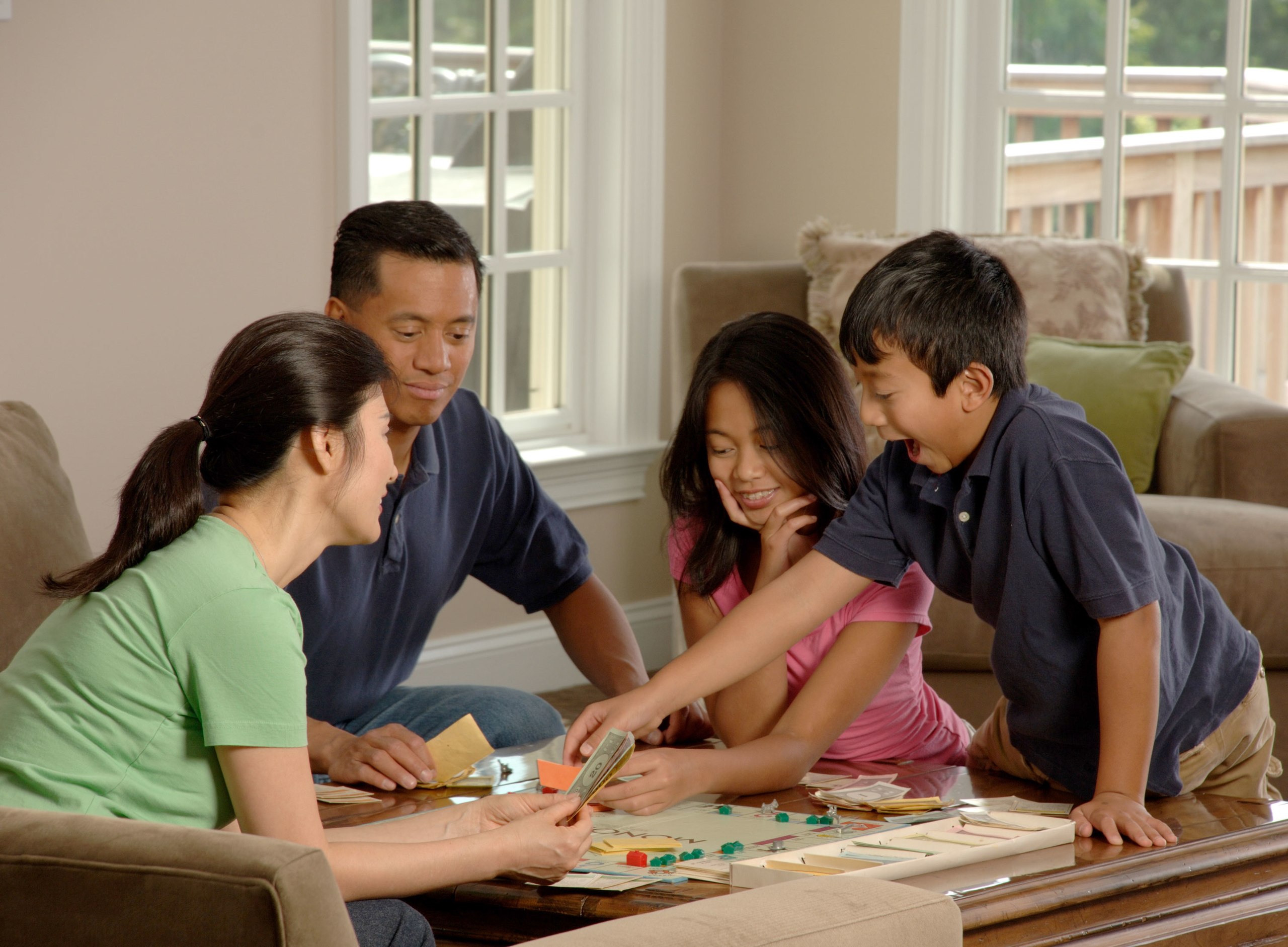 A family sitting together playing board games