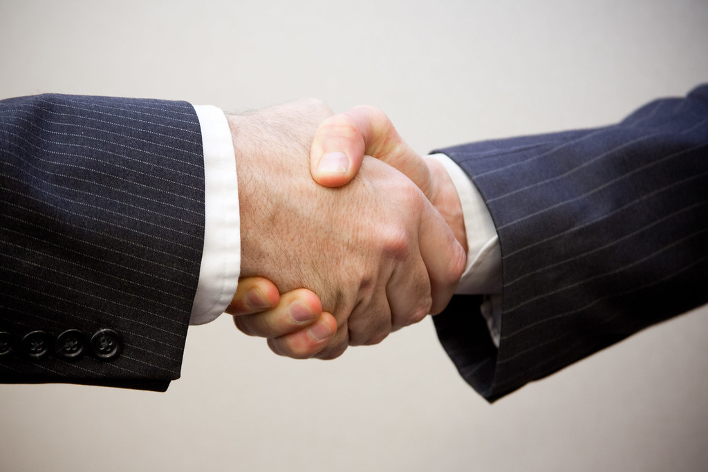A handshake or two people shaking hands