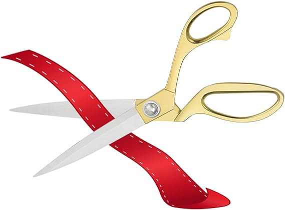 A pair of scissors cutting a ribbon