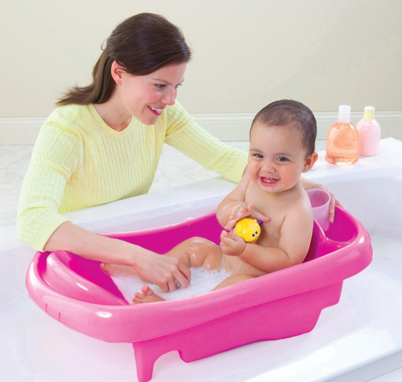 Baby being placed in a bathtub