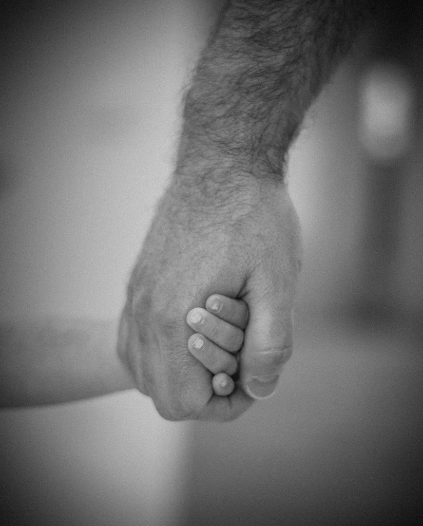 Father and daughter holding hands