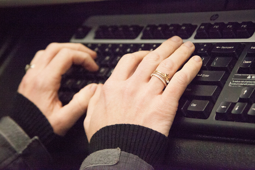 Image of a person typing on a computer keyboard.