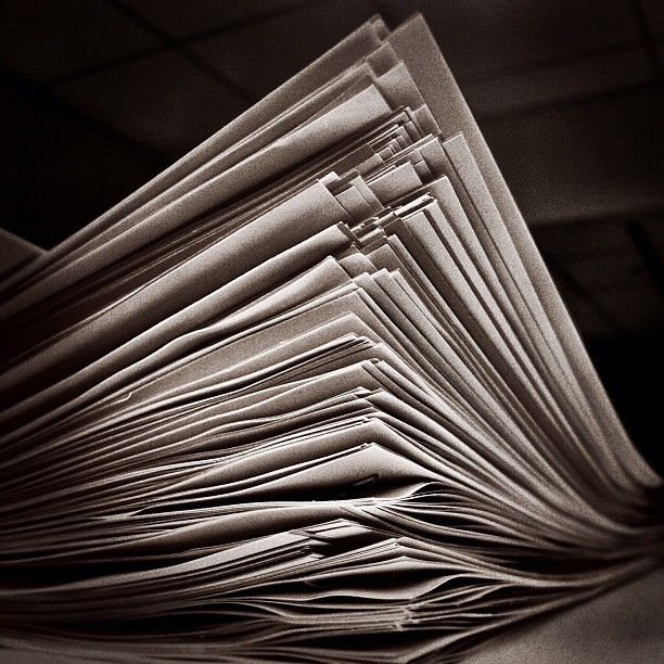Stack of papers with writing on them