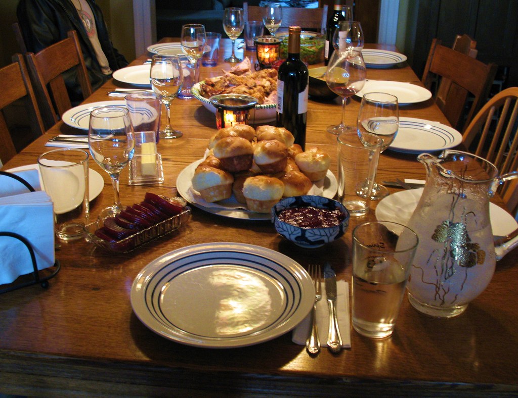 Thanksgiving dinner table with smiling guests