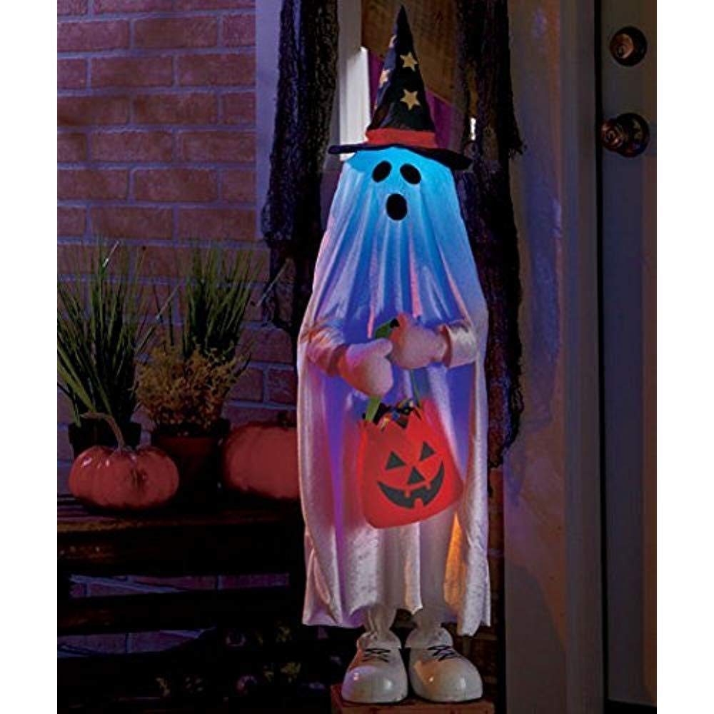 Trick-or-treater receiving candy at front door.